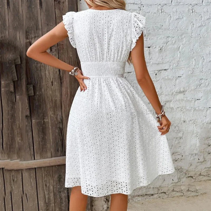 "Women's V-Neck eyelet summer dress with smocked waist, ruffled sleeves, and knee-length A-line in light fabric."