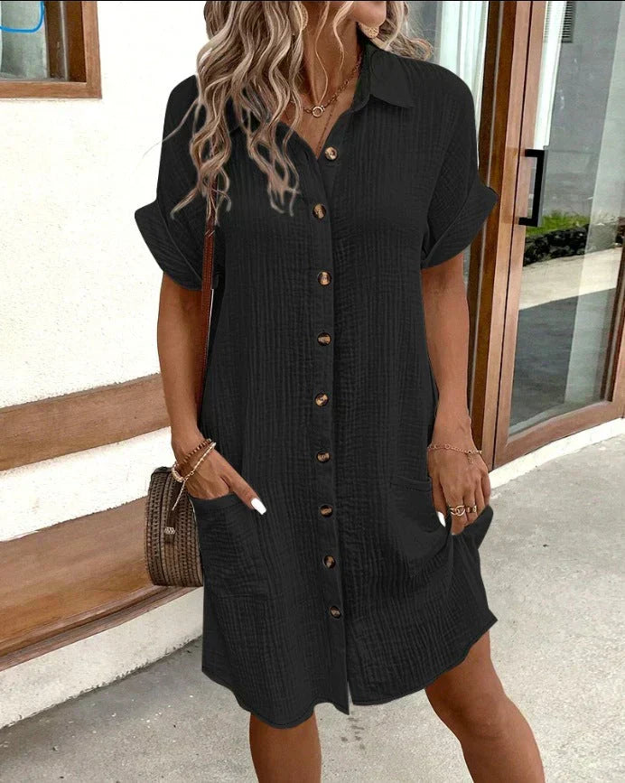 "Women's white cotton polo shirt dress with pockets, featuring a relaxed fit, polo collar, and wrinkle-resistant fabric."