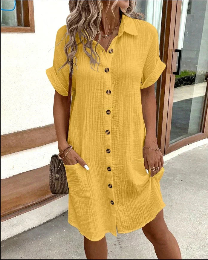 "Women's white cotton polo shirt dress with pockets, featuring a relaxed fit, polo collar, and wrinkle-resistant fabric."