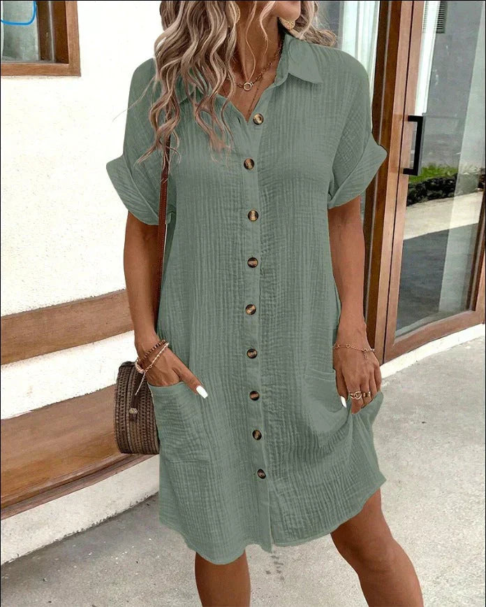 "Women's white cotton polo shirt dress with pockets, featuring a relaxed fit, polo collar, and wrinkle-resistant fabric."