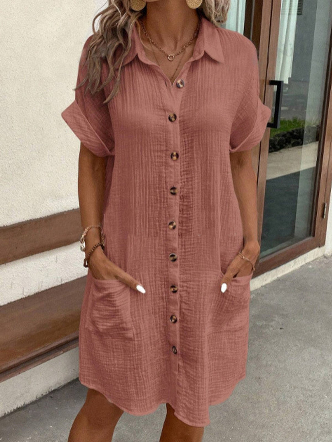 "Women's white cotton polo shirt dress with pockets, featuring a relaxed fit, polo collar, and wrinkle-resistant fabric."