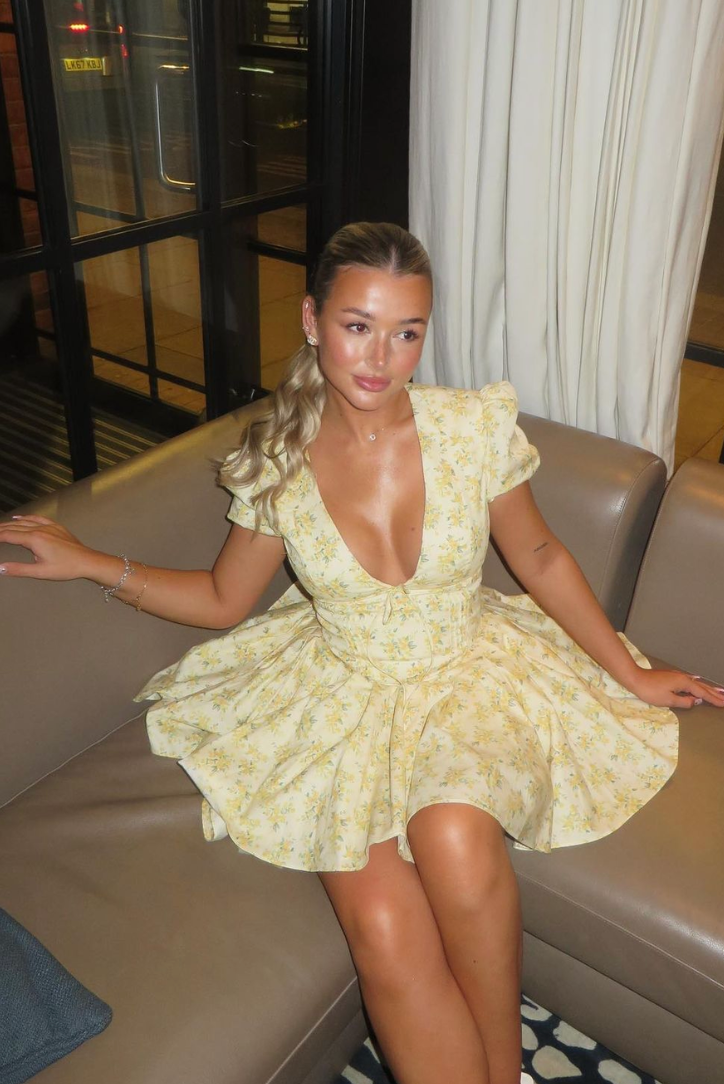 Women's floral puff sleeve A-line yellow mini dress with an alluring open back. Perfect short summer style.