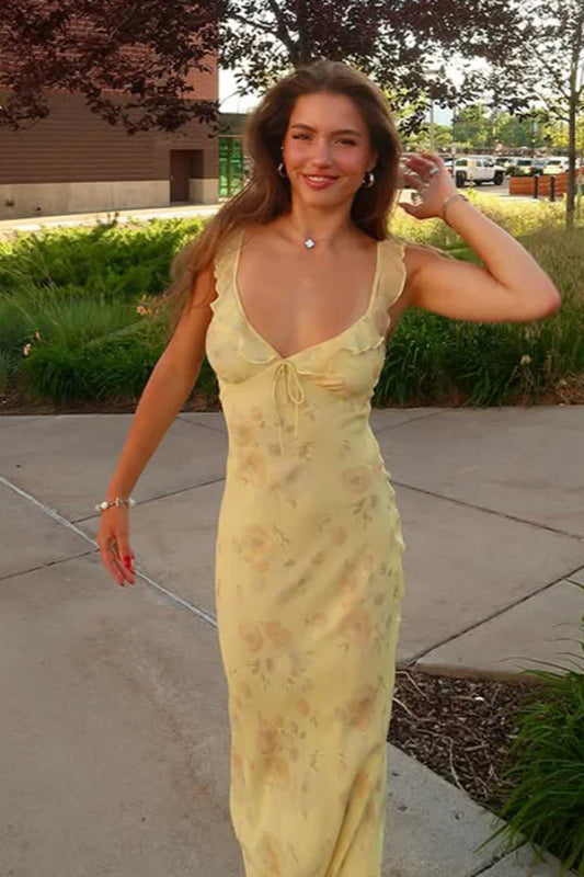 Flowy yellow floral maxi dress with spaghetti straps and scoop neck, a beautiful summer vacation dress.